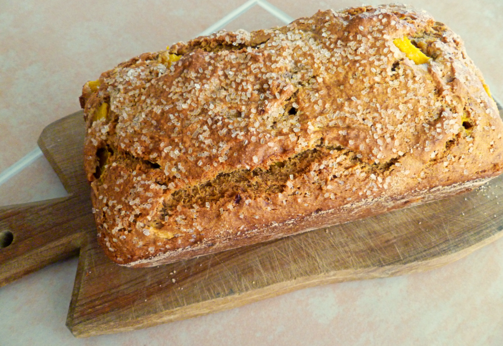 loaf of mango banana bread on cutting board