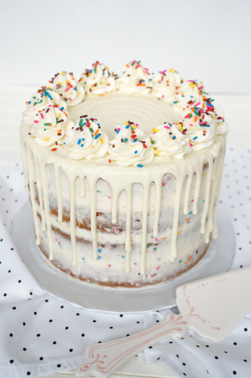 layered confetti drip cake