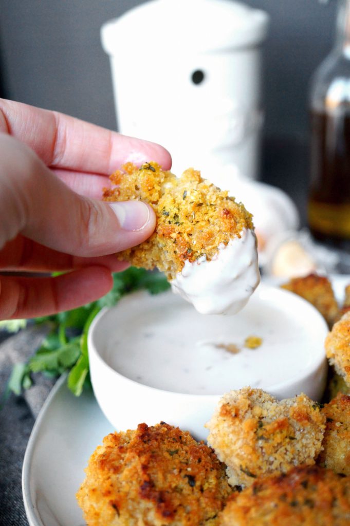 vegan garlic parmesan cauliflower wings on a plate with white dip.