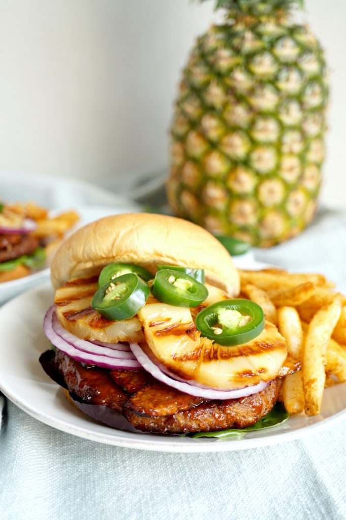 vegan aloha burger topped with grilled pineapple and jalapeño slices