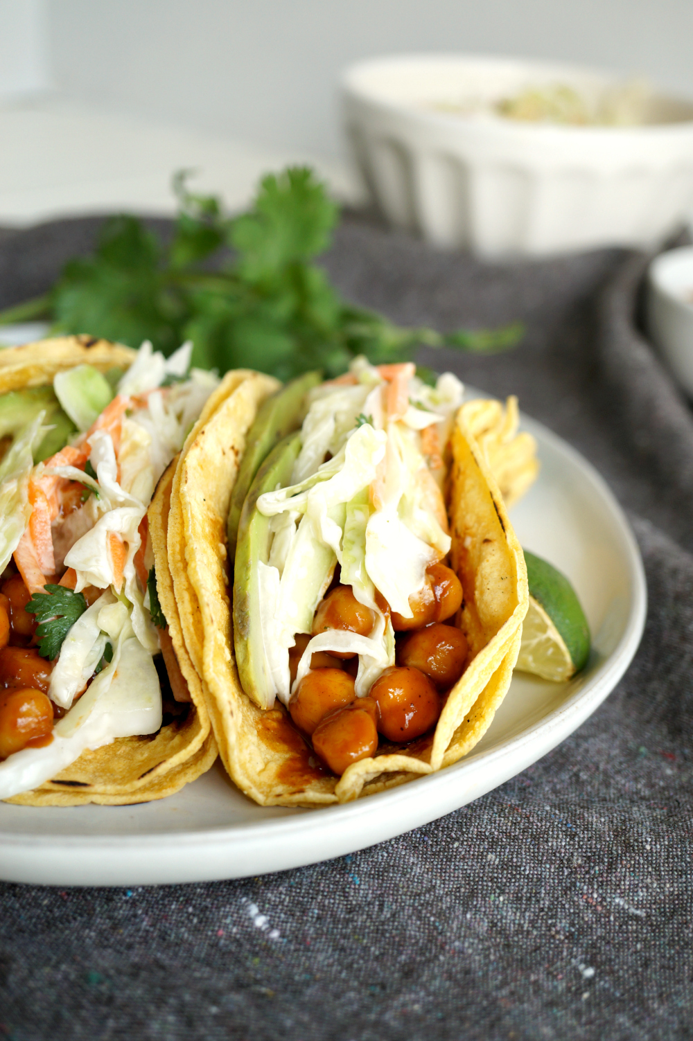 BBQ chickpea taco topped with coleslaw and sliced avocado