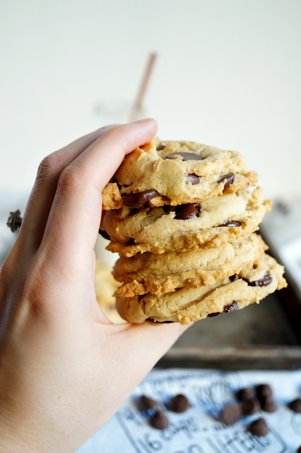 stack of vegan chocolate chip cookies in hand