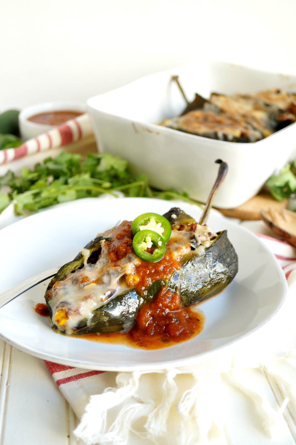 single stuffed poblano pepper on a plate