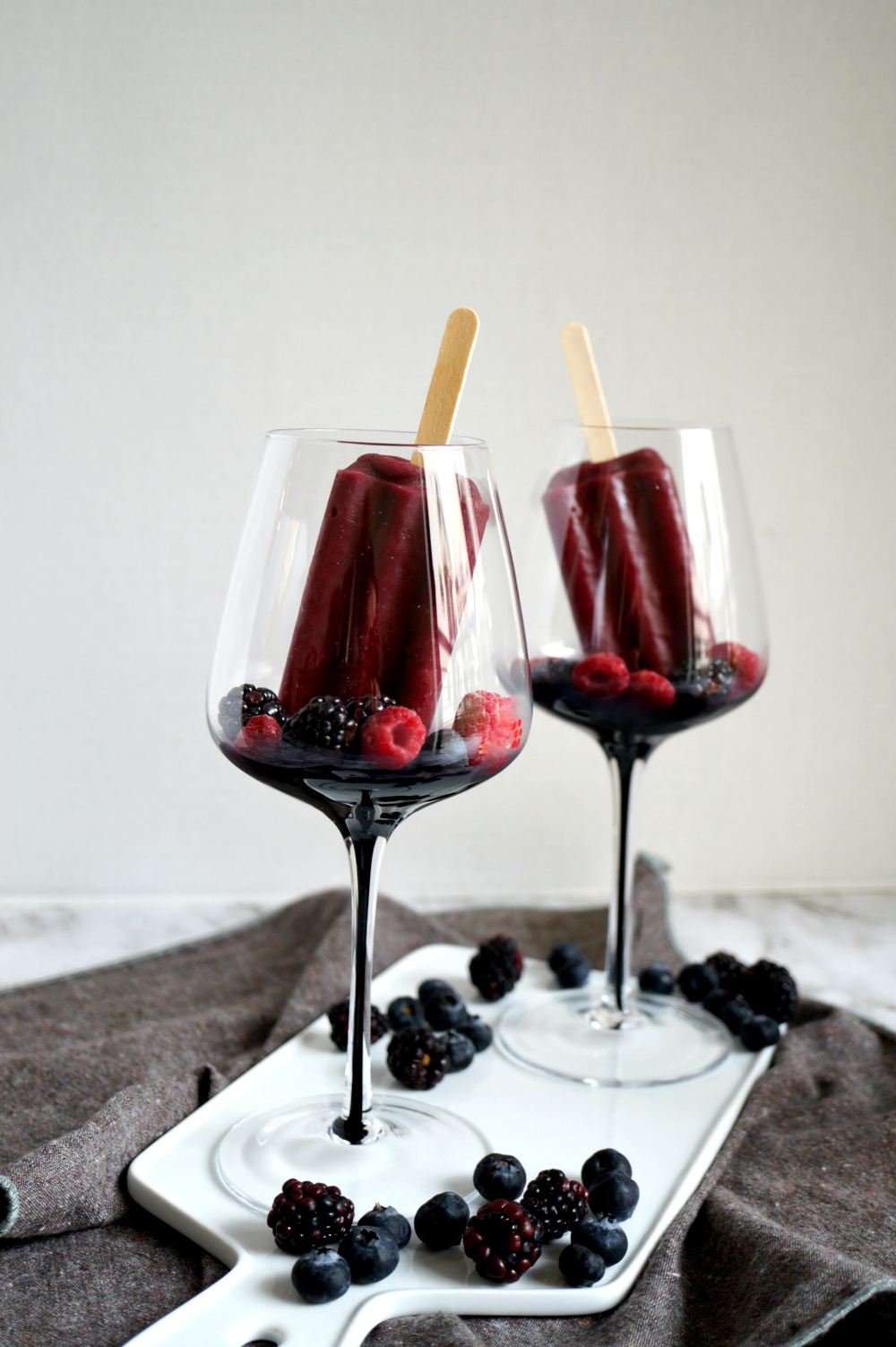 empty wine glasses with berries and popsicles