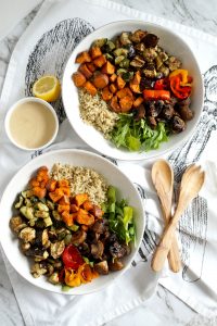 bowls of roasted vegetables, salad, and quinoa