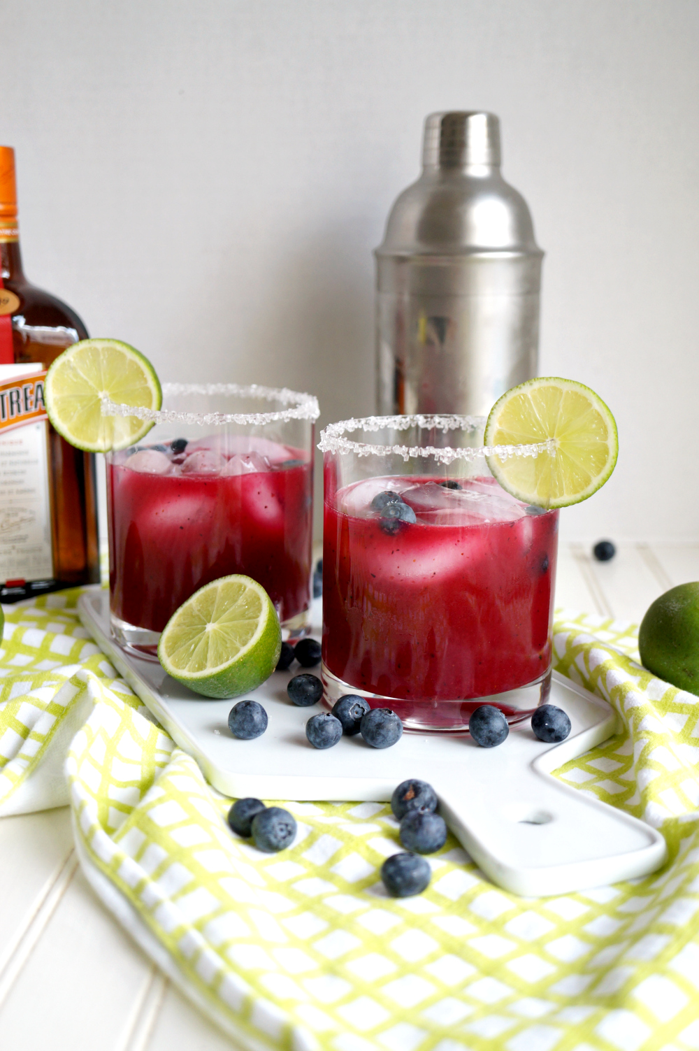 two glasses of blueberry lime margaritas