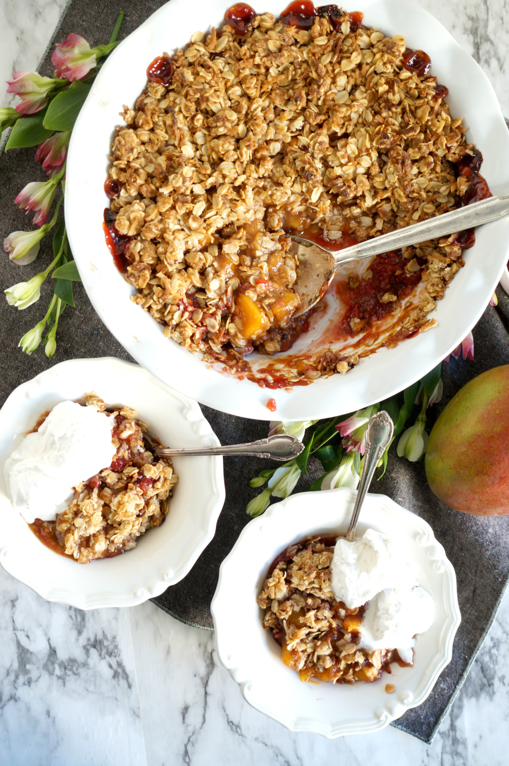 overhead bowls of mango raspberry crumble