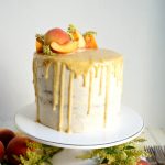 peaches & cream layer cake on stand