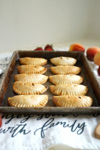 strawberry peach hand pies on a baking sheet