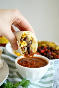 breakfast burrito dipped in salsa