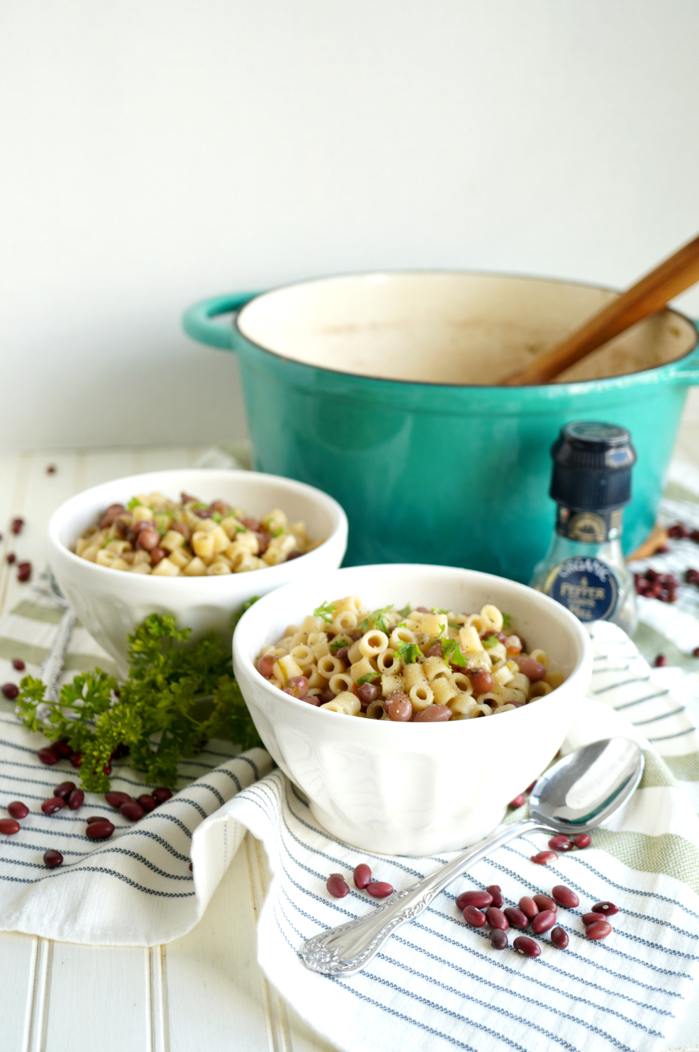 bowls of pasta e fagioli with cooking pot