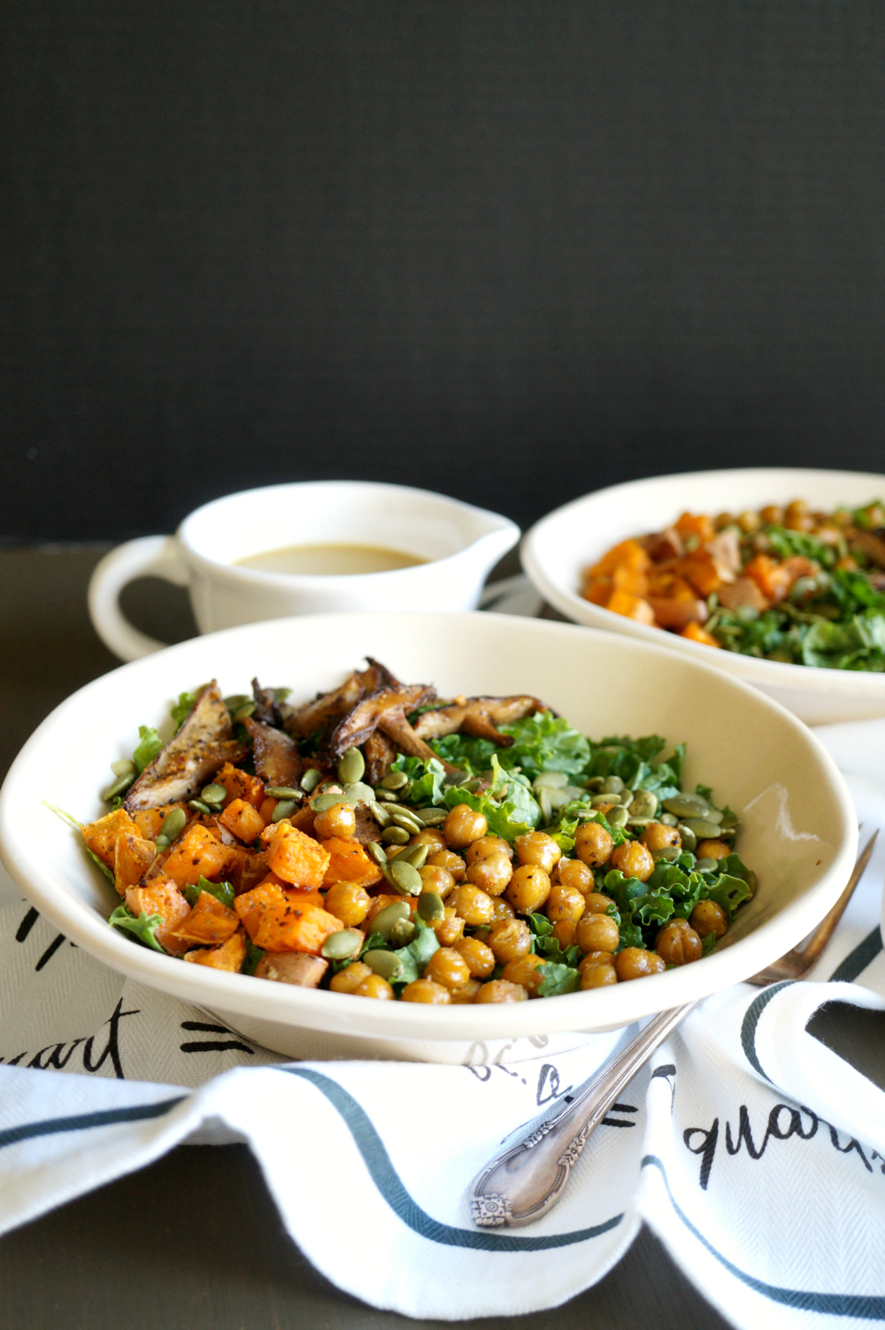 bowl of kale salad with sweet potato, chickpeas, mushrooms