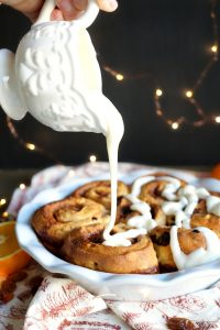 pouring glaze on panettone rolls