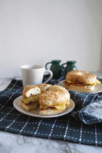 two breakfast bagel sandwiches