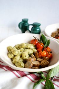plate of gnocchi with sausage and tomatoes