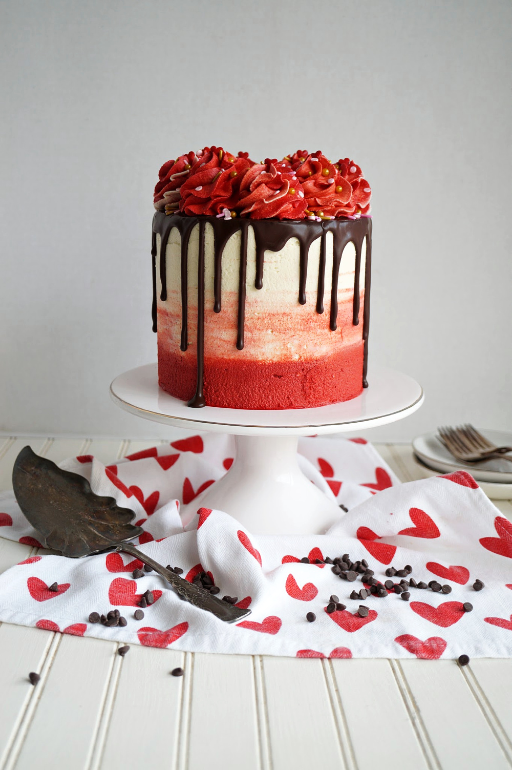 red velvet chocolate chip cake on stand