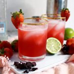 two glasses of strawberry hibiscus margaritas