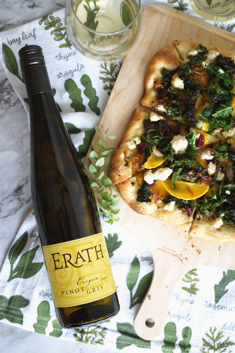 overhead shot of wine bottle and pizza