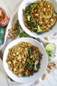 overhead shot of two bowls of peanut noodles