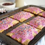 baking tray full of pink strawberry pop tarts