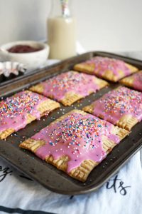 baking tray full of pink strawberry pop tarts