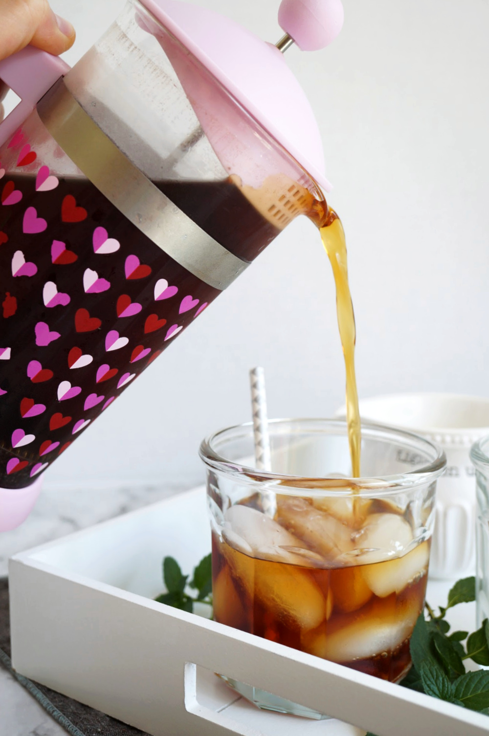 pouring cold brew into cup