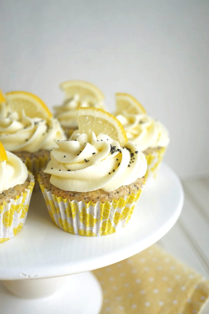 lemon poppyseed cupcake on cake stand