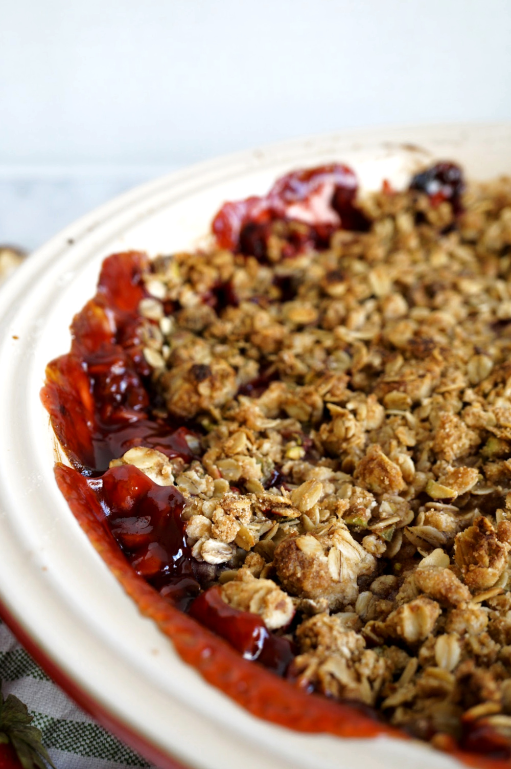 close up of crumble oat topping on strawberry crisp