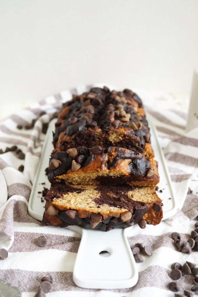 marble banana bread sliced on a cutting board