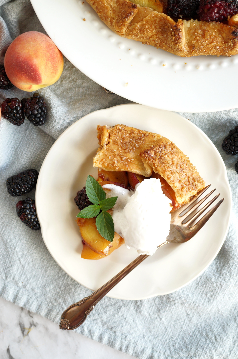 overhead photo of a slice of galette with ice cream and mint