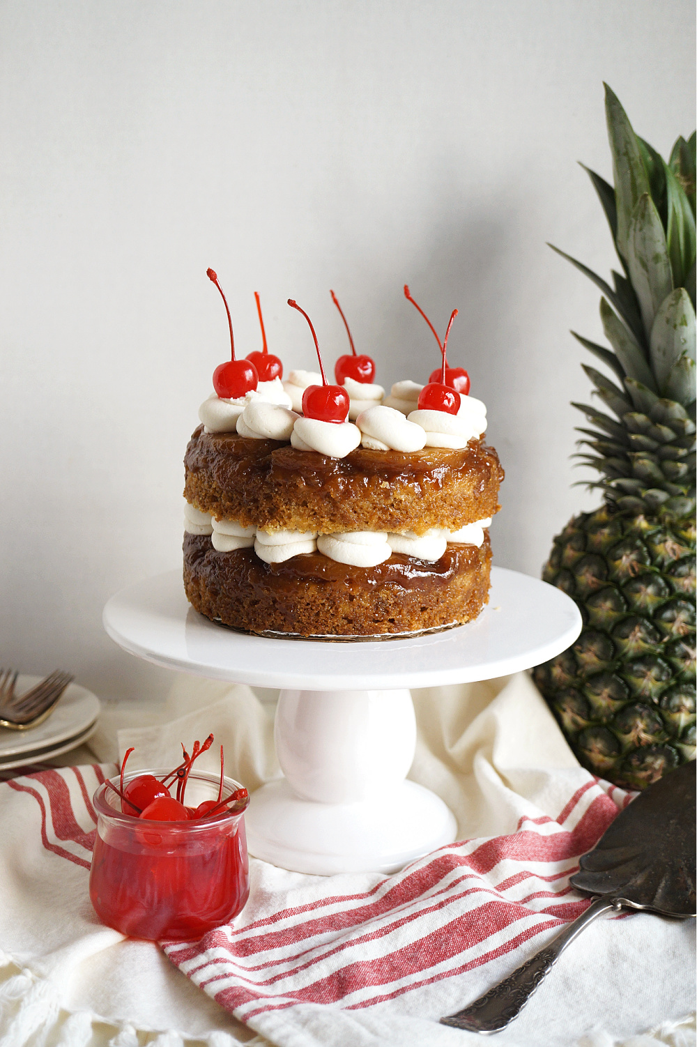 vegan pineapple upside down layer cake on cake stand