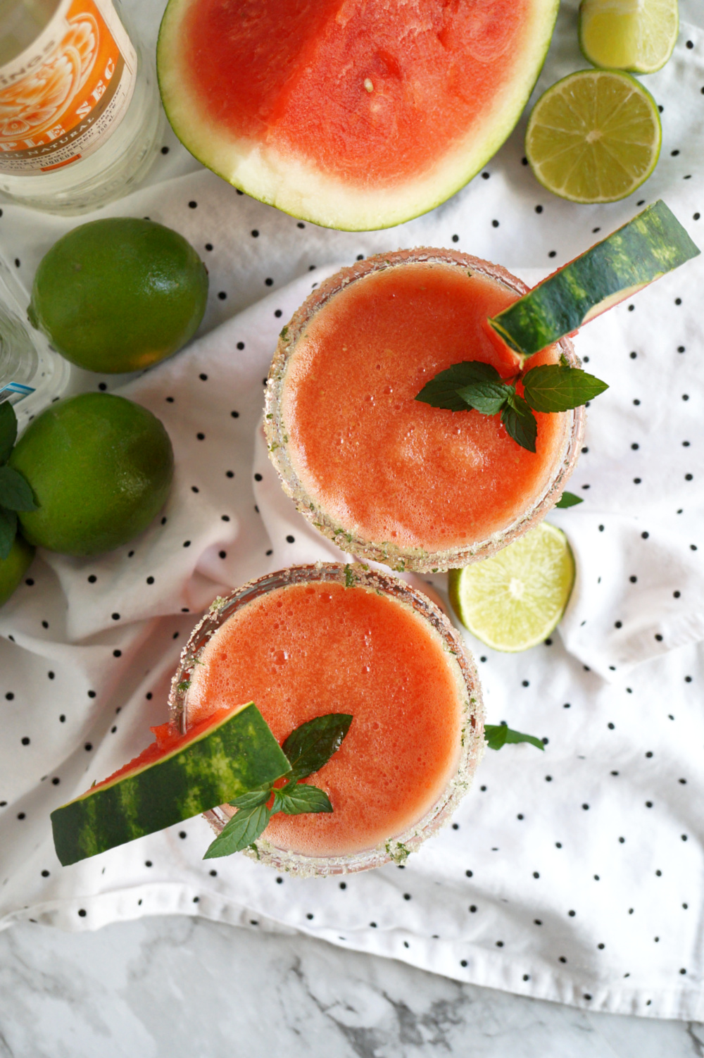 overhead shot of two cups of watermelon margaritas