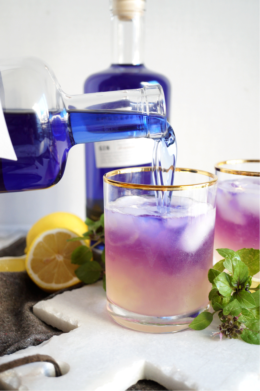 pouring gin into cup of lemon juice