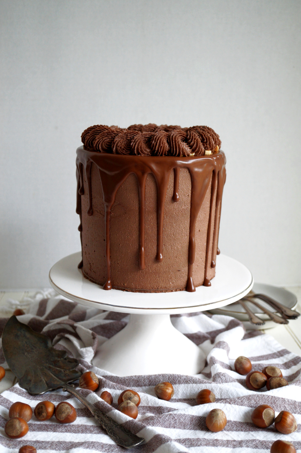 chocolate hazelnut layer cake on cake stand