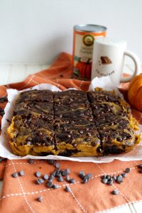 head-on shot of pumpkin swirl brownies on parchment