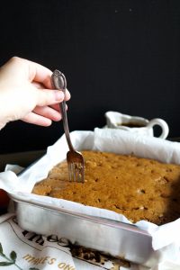 poking surface of cake with a fork