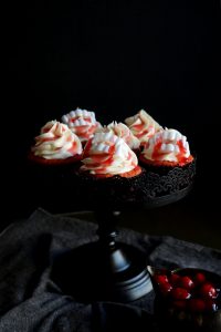 red cupcakes with cherry juice drip and plastic vampire teeth