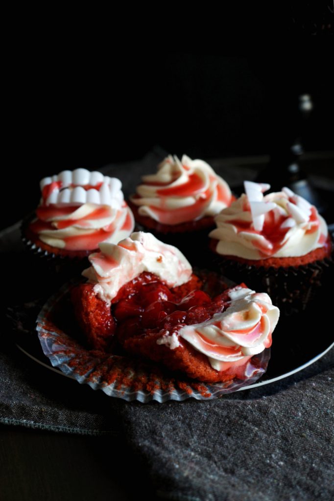 cherry cupcake cut open with cherry pie filling inside