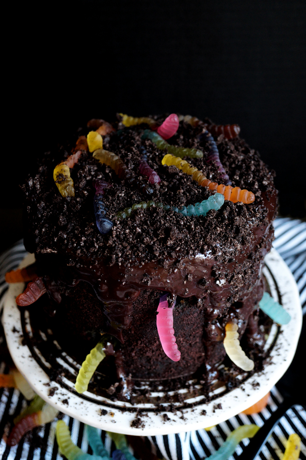 angled shot of a vegan dirt & worms cake with gummy worms