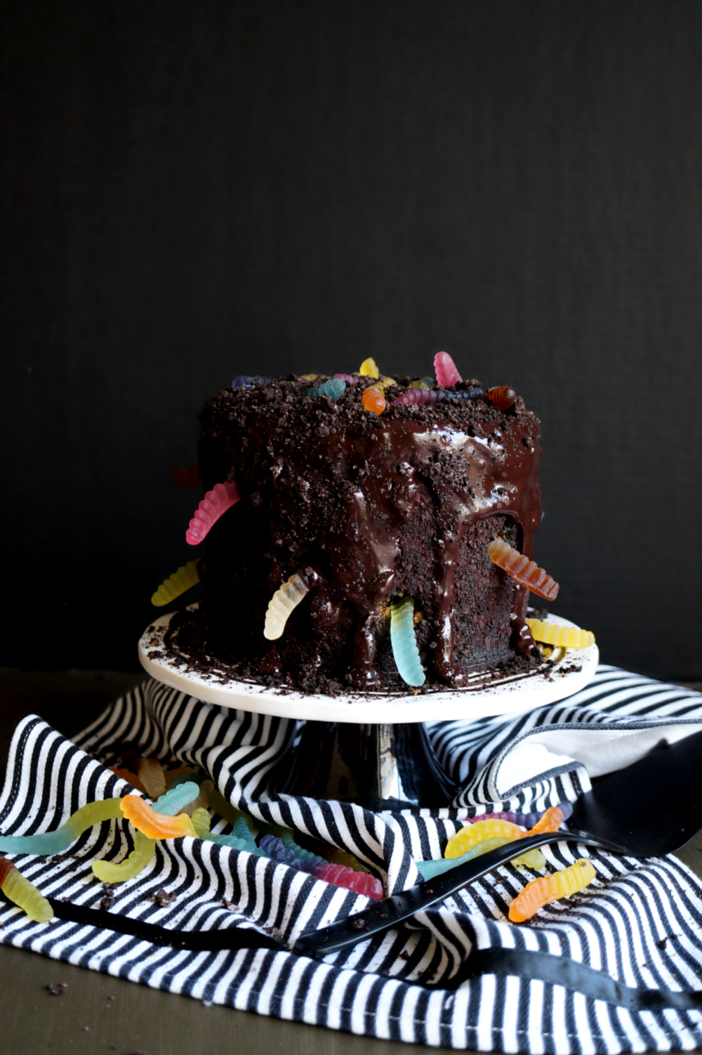 dirt & worms cake on cake stand with gummy worms