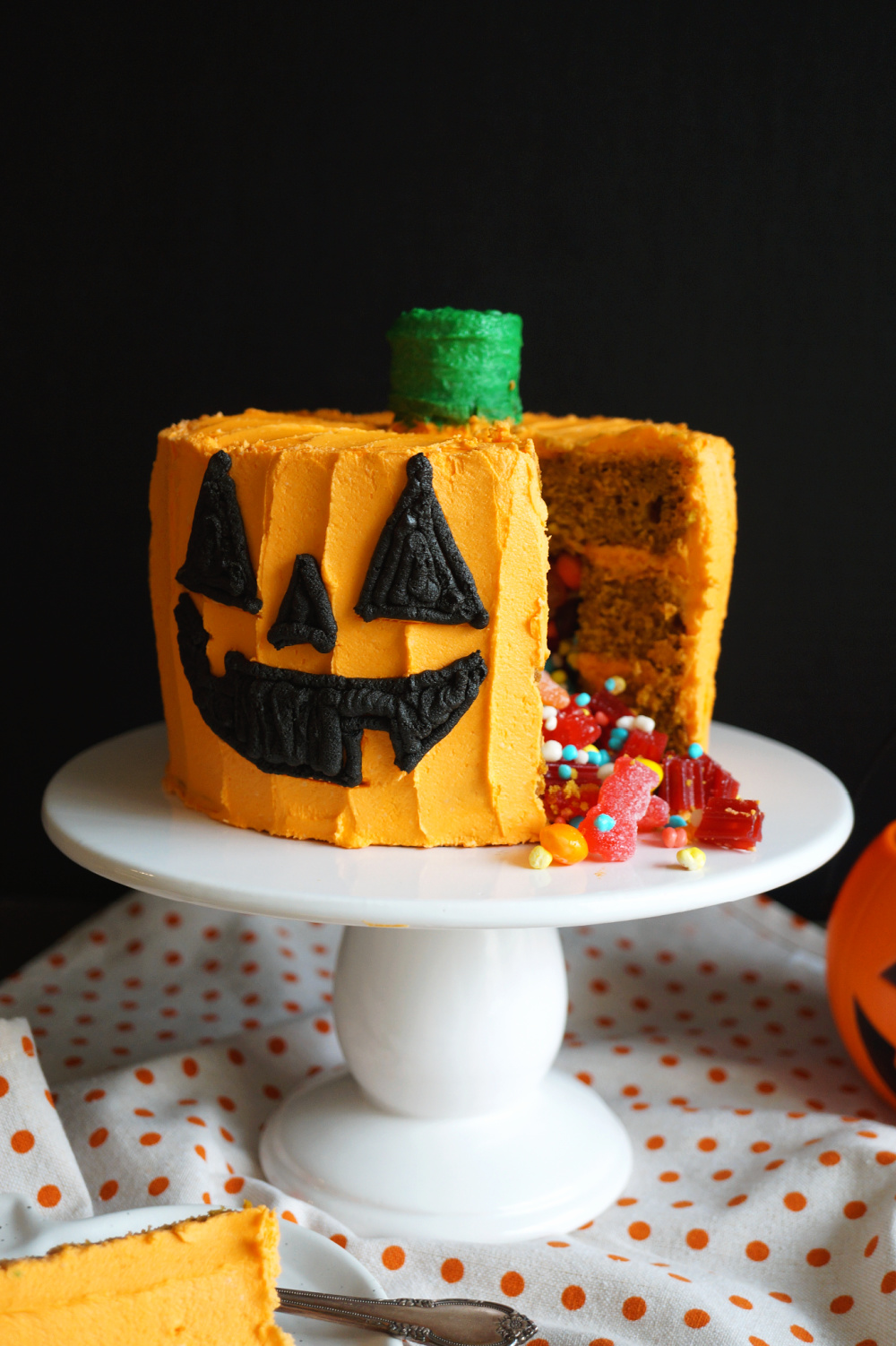 pumpkin cake with slice cut and candy pouring out