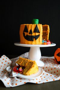 jack o'lantern cake with candy and slice on plate