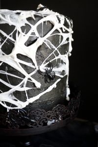 close up of side of marshmallow spiderweb cake