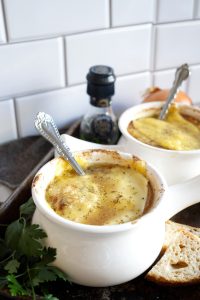 close up shot of melted cheese on onion soup