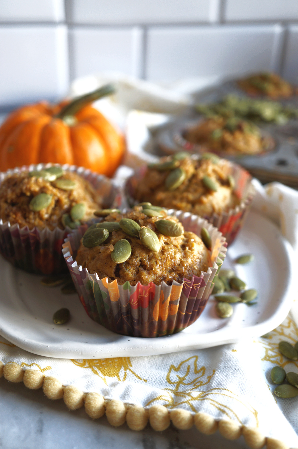 muffins on a plate with pumpkin seeds