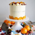 cranberry clementine cake on white cake stand