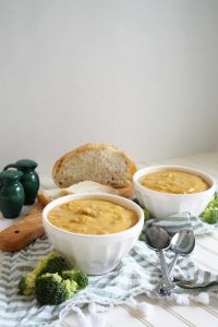 two bowls of broccoli cheese soup