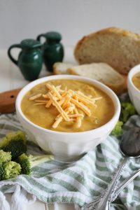 bowl of broccoli cheese soup with shredded cheese on top