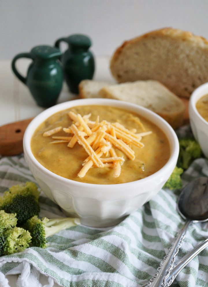 bowl of broccoli cheese soup with shredded cheese on top