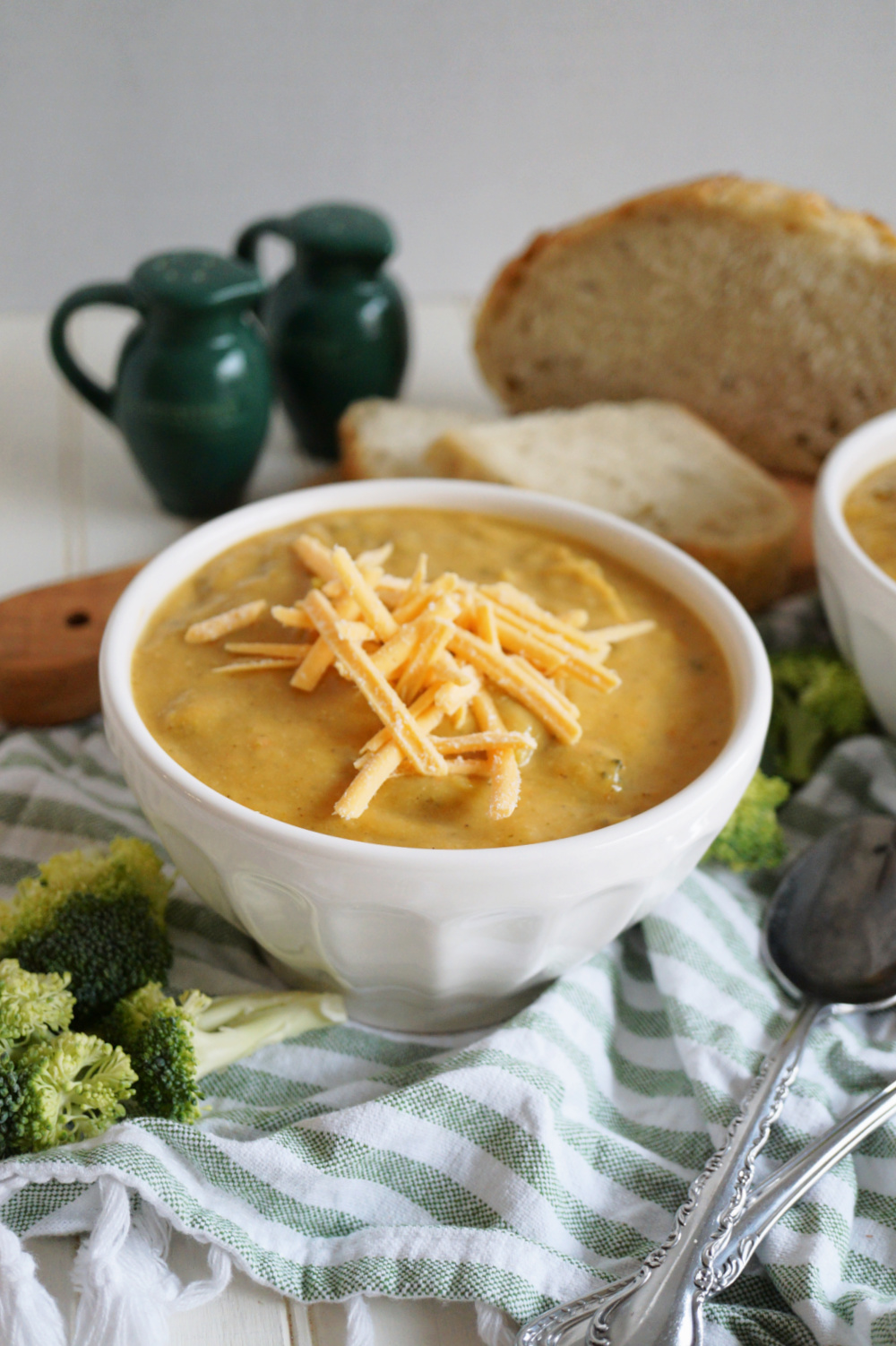 bowl of broccoli cheese soup with shredded cheese on top